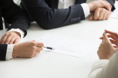 negotiations-about-contract-terms-concept-hand-pointing-document-closeup negotiations-about-contract-terms-concept-hand-pointing-document-closeup